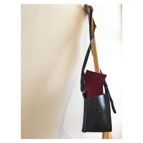 Red suede lined bag with reclaimed saddlery strap