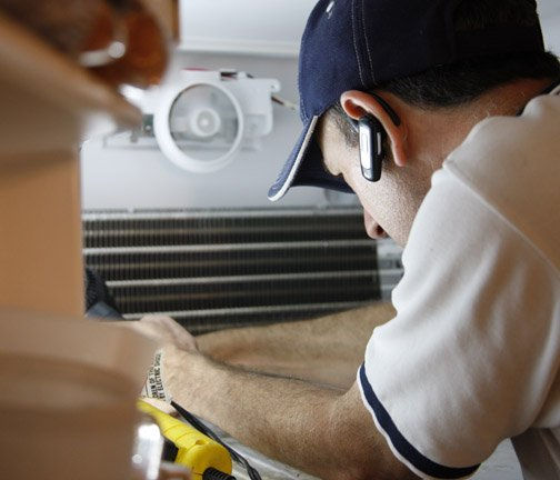 Appliance repair professional at work