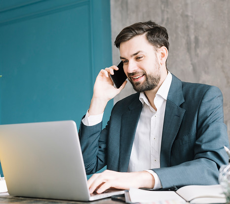 businessman-speaking-phone-near-laptop.j