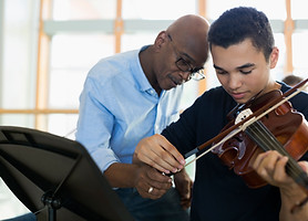 Teacher Helping Student Playing Violin