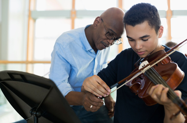 Teacher Helping Student Playing Violin
