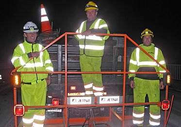 Three construction workers on a hitch.