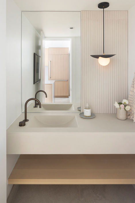 Modern powder room with floating vanity and custom finishes in West 3rd home