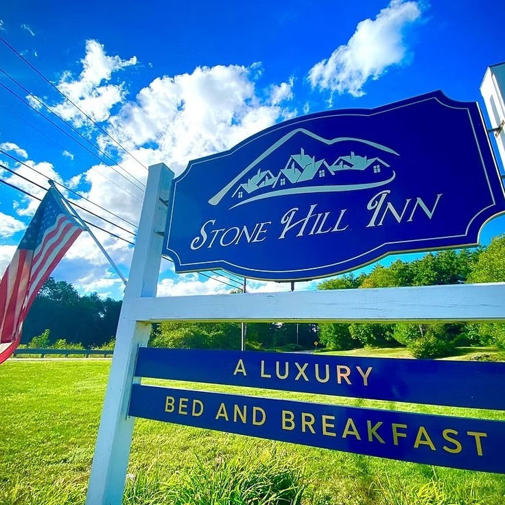 Award winning Stone Hill Inn entry signage with american flag