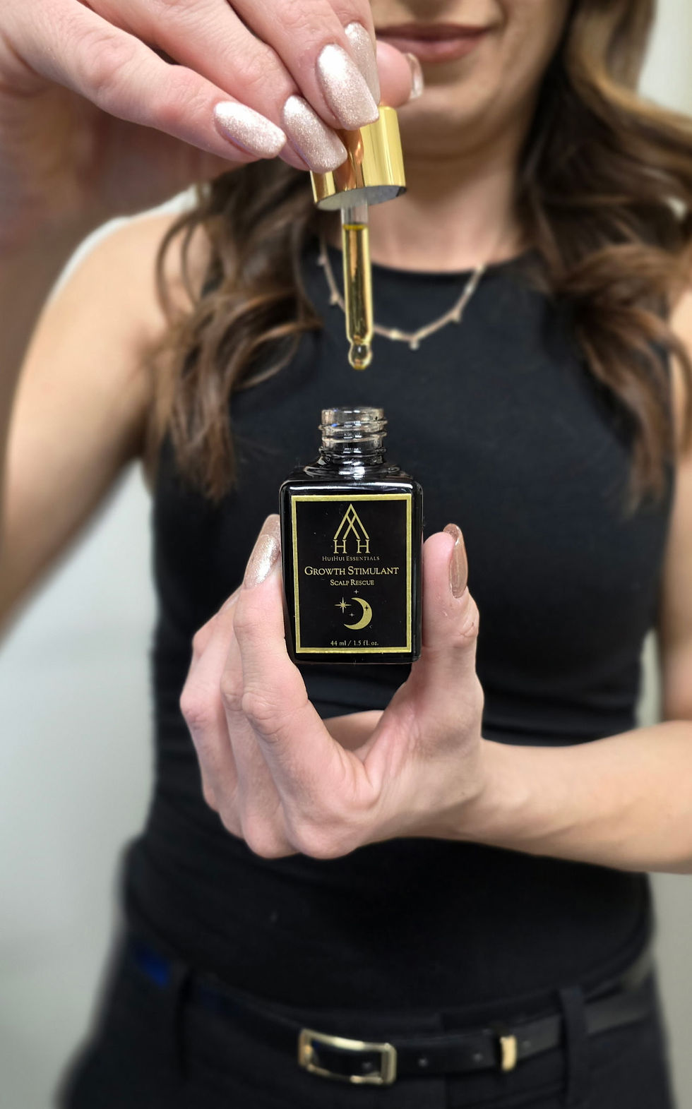 Luxurious scalp oil made with fresh herbs, emphasizing natural ingredients.