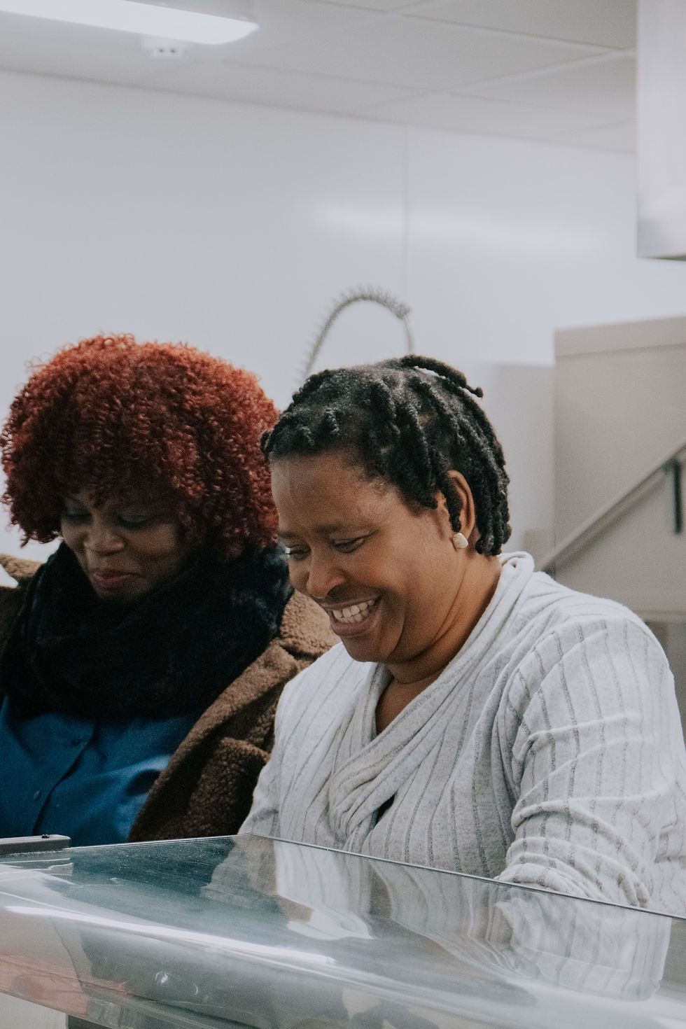 Woman smiling while serving tea and coffee.