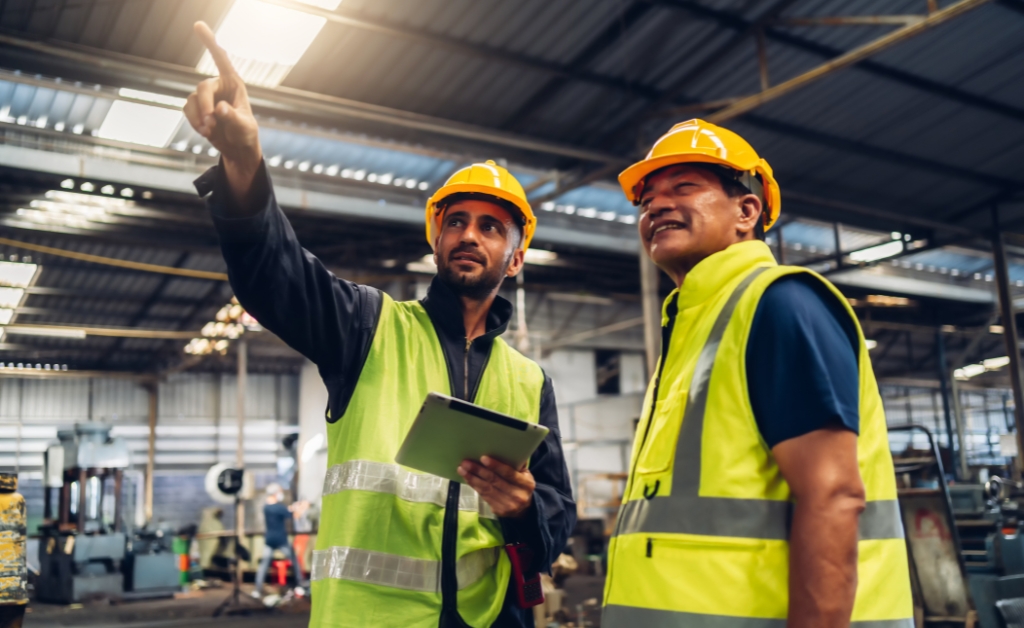 two workshop workers discuss safety within their warehouse
