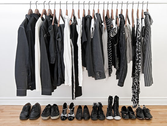black and white clothes on a hanging rack