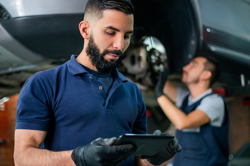 Automotive technician using tablet 