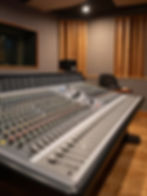 Professional mixing console in a recording studio with acoustic treatments