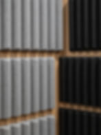 Grey and black acoustic treatment panels on a wall.