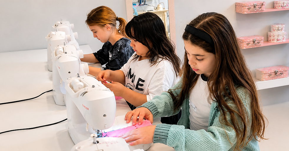 Students are practicing their sewing skills as they prepare for the Fashion Show.