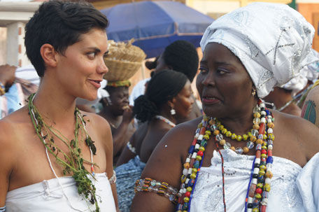 Two women in traditional attire at a spiritual gathering.