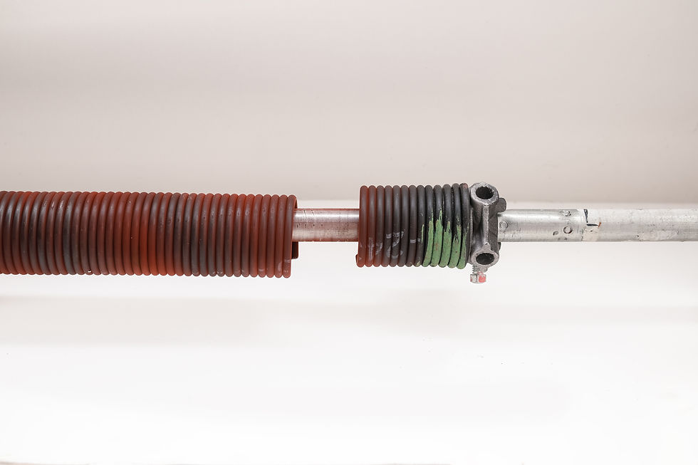 Broken garage door spring or torsion spring from overhead sectional door inside. Sheared-o