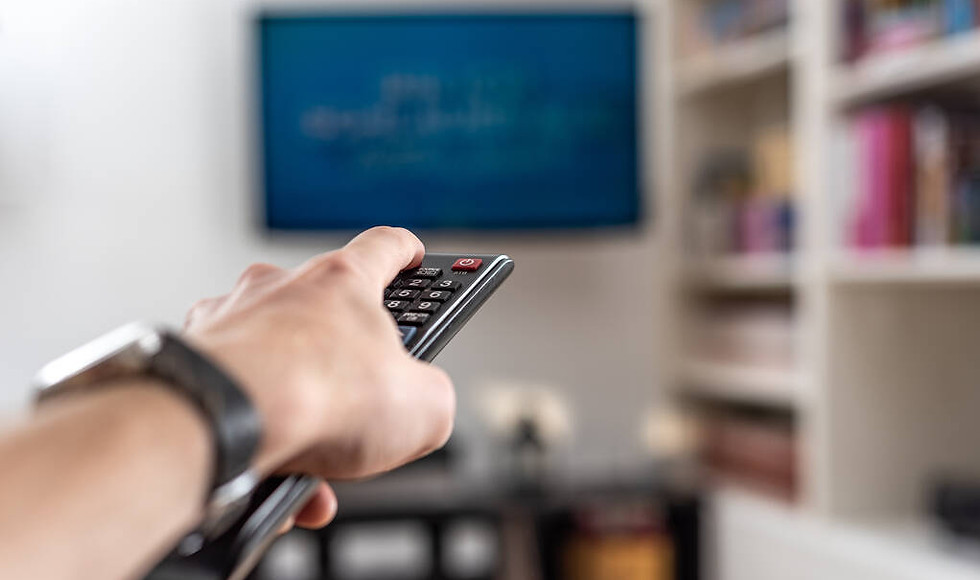 stock-photo-man-switching-channels-on-plasma-tv-with-remote-control-at-home.jpeg