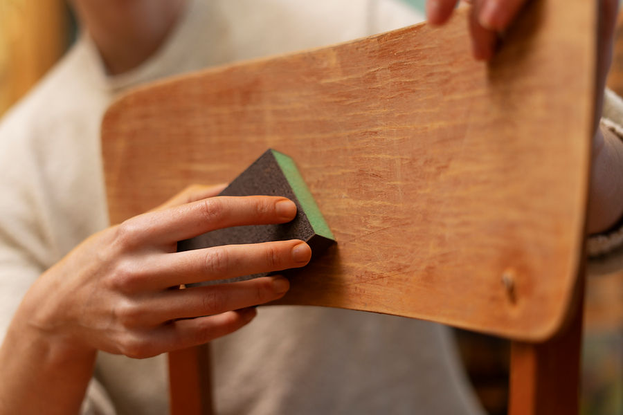 side-view-woman-restoring-wooden-chair.jpg