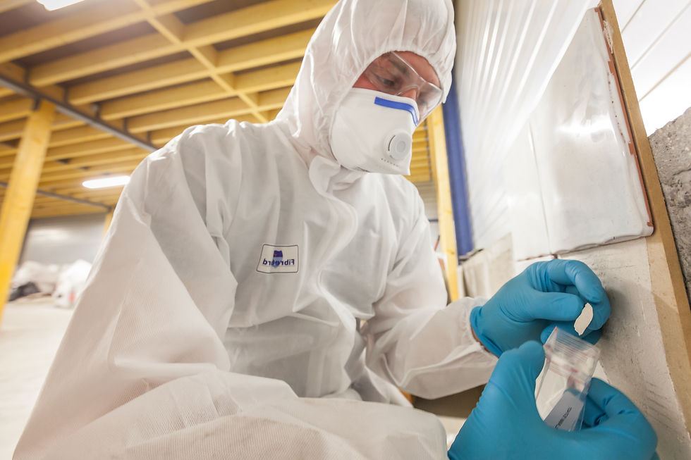 Asbestos surveyor taking a sample of building material, detection of asbestos, in accordan