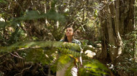 Janene walking in a river bed in a forest on Table Mountain