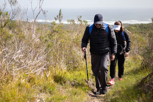 Team walking with ocean in the background on Table Mountain in Cape Town, South Africa