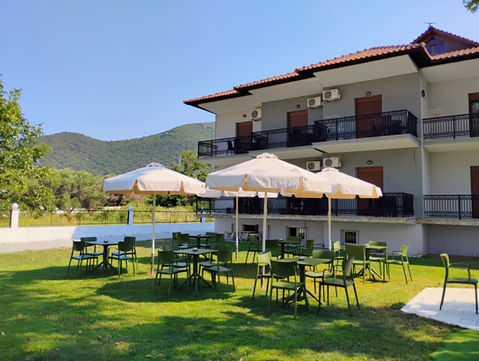 Alex Rooms Stavros hotel exterior with patio seating