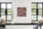 Colourful abstract painting by Cherrie Mansfield in a modern living room centred on a white wall between two large black-framed windows
