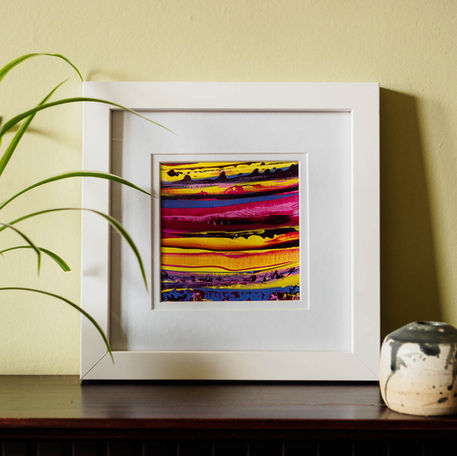 Small framed abstract painting featuring of magenta, violet, mauve and yellow.