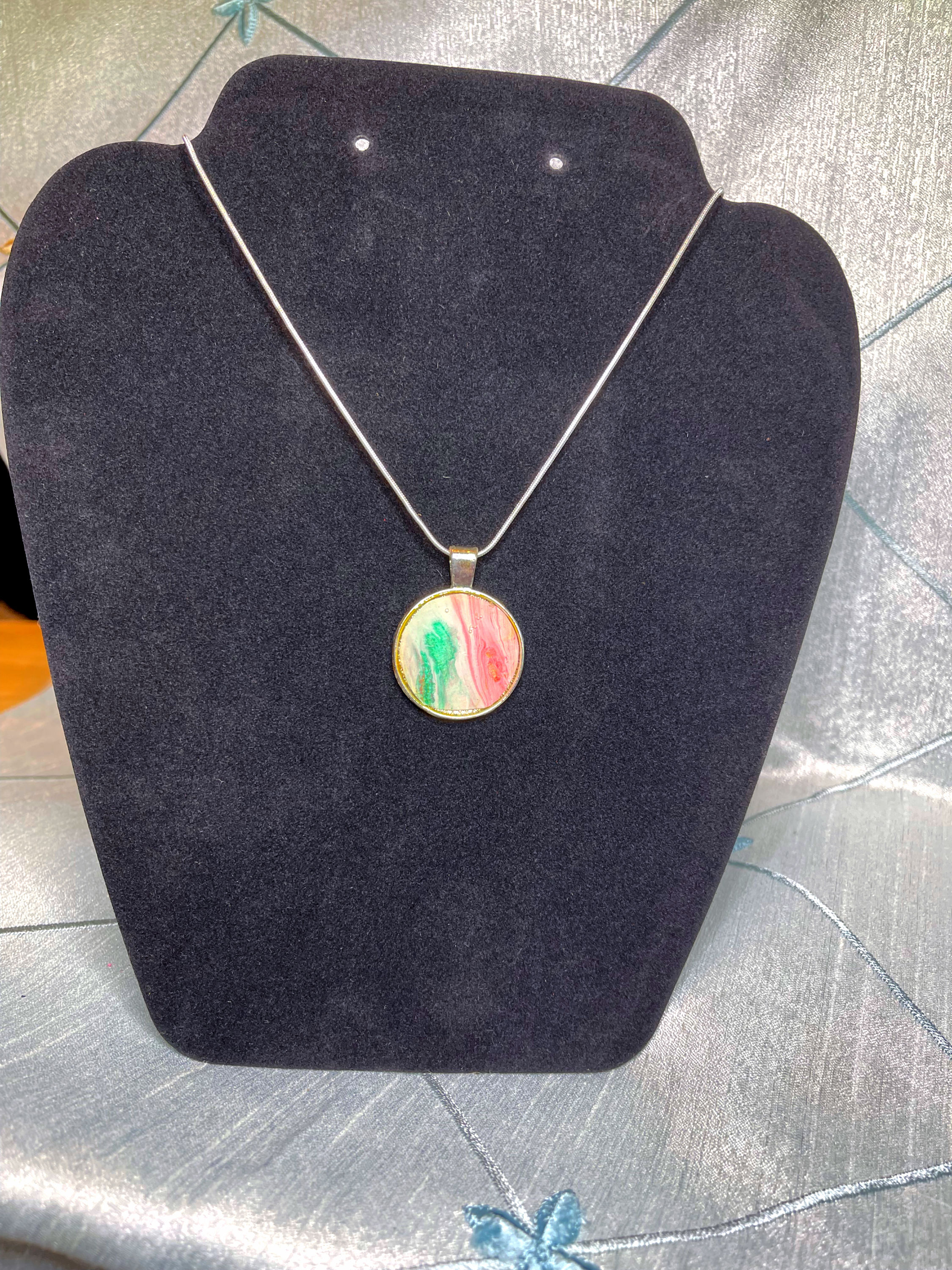 maroon, green and white fluid art necklace.