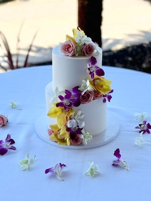 2 tier wedding cake-white icing-tropical vibe-hawaii vibe-plumeria-orchids -Bali Hai-San Diego