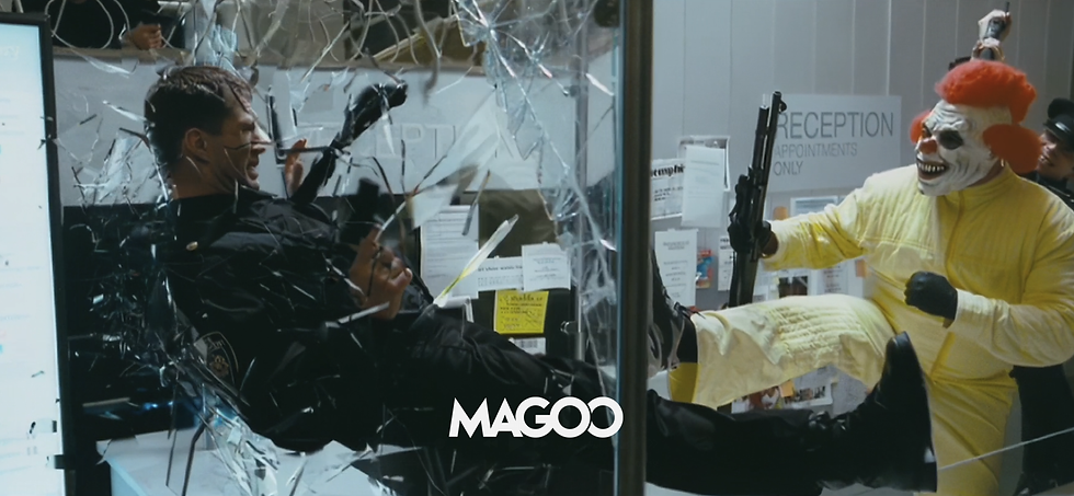 Riot police officer kicked through glass by a clown in yellow with a gun. Shattered glass, "RECEPTION" sign and papers visible. Tense scene.