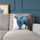 Thumbnail: Blue Highland cow cushion on sofa