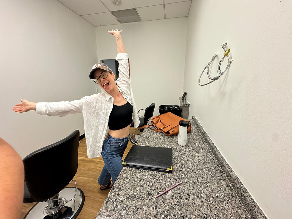 Me, with arms spread wide, super excited about being in the bare bones of my tiny new salon studio!