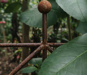 garden Gems, rusted garden stake in lush greenery