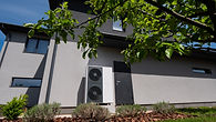 wall-modern-cottage-hosts-outdoor-unit-heat-pump.jpg