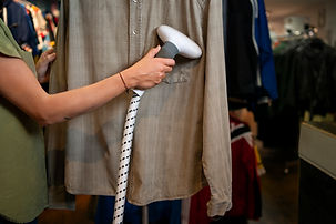 woman-cleaning-clothing-thrift-store.jpg