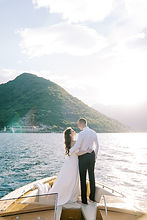bride-groom-are-standing-hugging-bow-yacht-sailing-sea-back-view.jpg