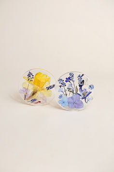 Two unique floral art pieces with yellow and blue flowers on white background.
