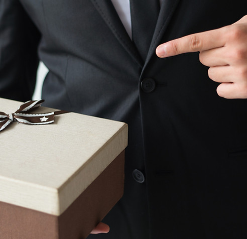 unrecognizable-businessman-holding-brown-gift-box.jpg