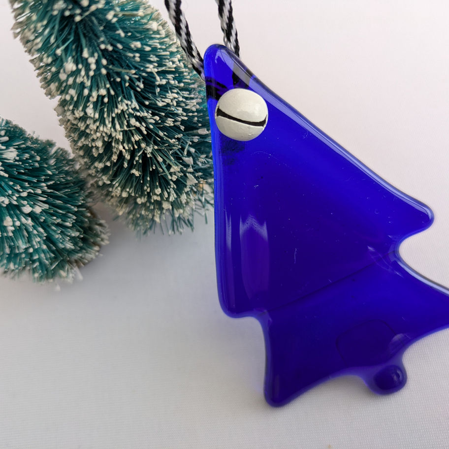 Blue fused glass Christmas tree ornament with a small silver bell detail.