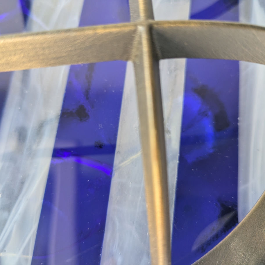 Round nautical ship wall light sconce with blue and yellow fused striped glass.