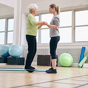 Trainer exercising with senior