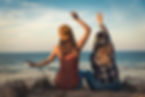 two humans looking at the beach and having a good time