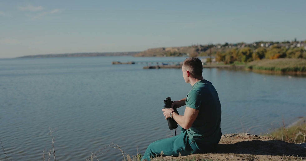 man-tourist-looking-through-binoculars-sitting-on-2025-12-17-22-33-27-utc.mov