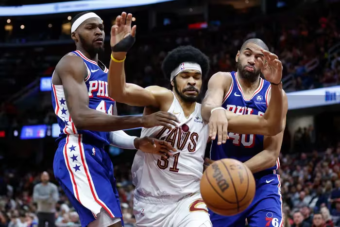 Cleveland Cavaliers center Jarrett Allen fights Sixers forwards Paul Reed and Nico Batum for a rebound during Friday's game. Ron Schwane / AP