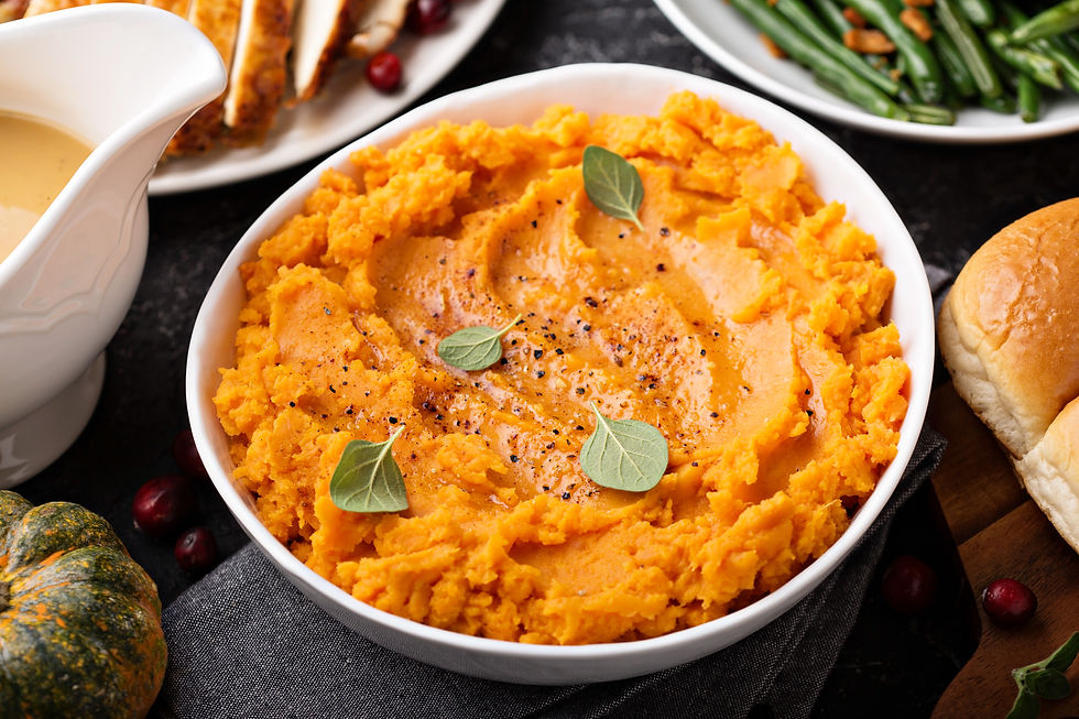 A bowl of mashed potatoes topped with pepper and sage.