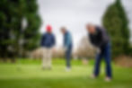 Senior friends playing golf.
