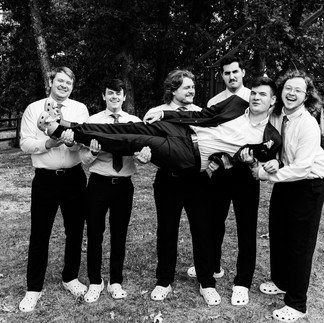 Groomsmen wearing green Shrek Crocs at Weathered Wisdom Barn wedding