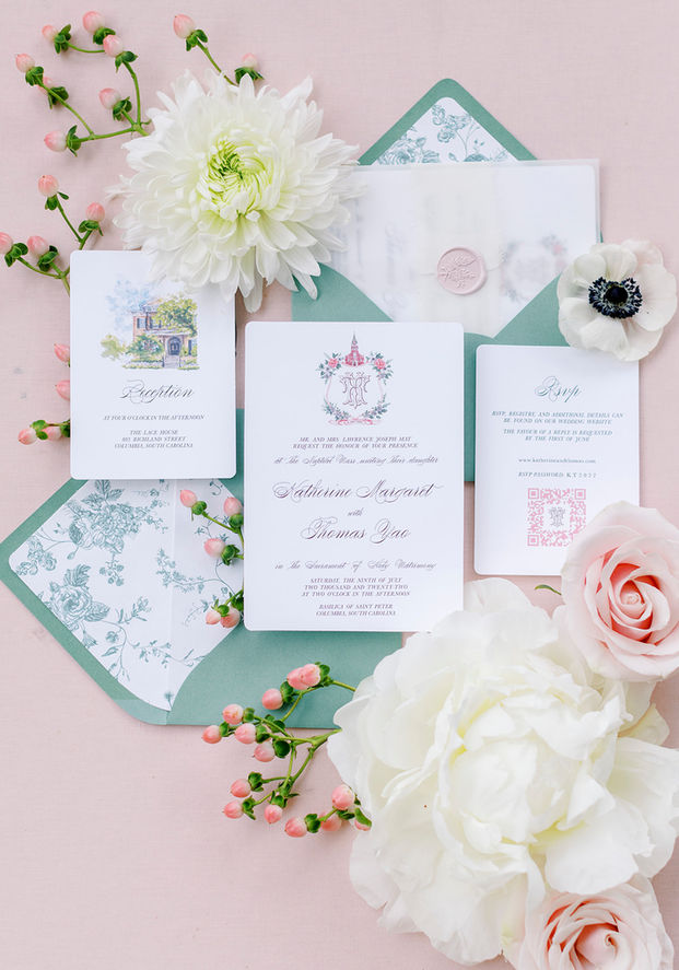 Flat lay of wedding invitation suite with floral accents for a Lace House wedding.