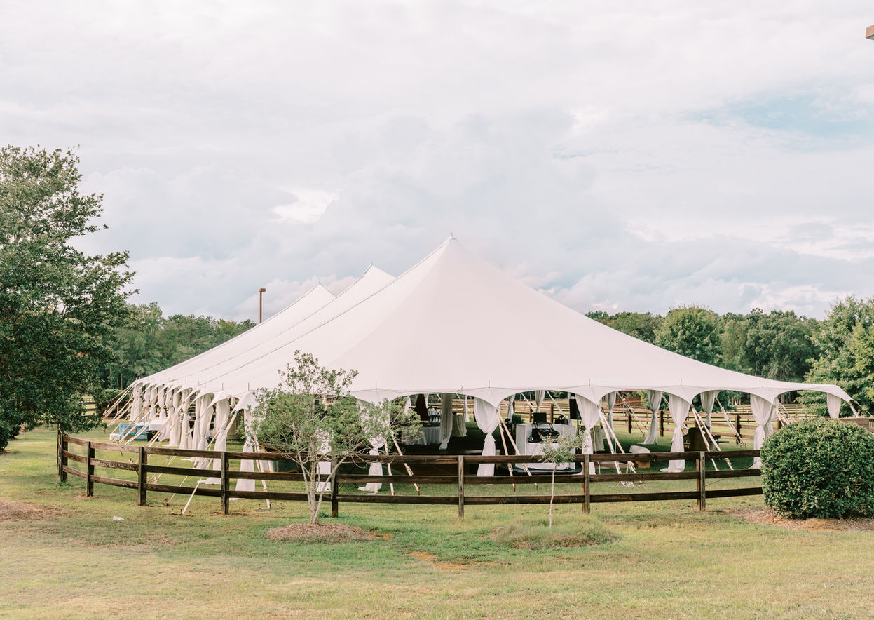 Sailcloth reception tent at The Farm at Ridgeway set for an outdoor wedding celebration.