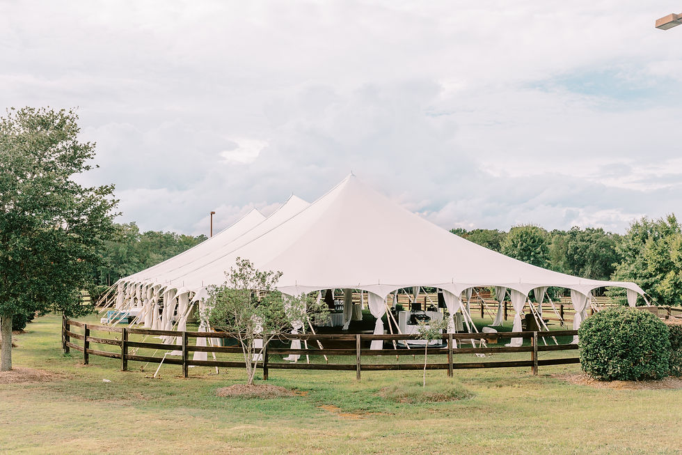 Sailcloth tent wedding reception at The Farm at Ridgeway, surrounded by open fields and greenery.