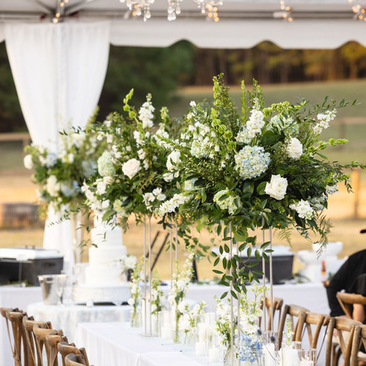 Elegant tented wedding reception with tall floral centerpieces and white draping at a private estate in Aiken, SC, planned by Eventfully Chic Planning & Coordination.